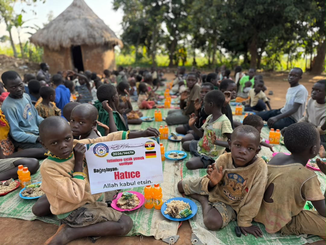 Children smiling outside their community school in Uganda